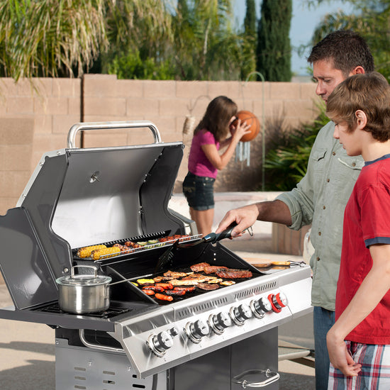 Family grilling outdoors with a large Royal Gourmet barbecue grill.