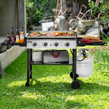 Royal Gourmet Portable grill with food and drinks on a grassy outdoor area