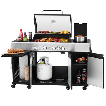 A large stainless steel and black Royal Gourmet gas grill cart with an open lid, cooking food on the grates, a side shelf with hot dogs and condiments, a pot on the burner table, and open lower and side cabinets holding a propane tank, towels, and bottles, shown on a white background.
