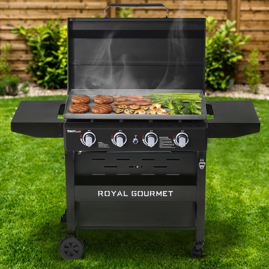Black Royal Gourmet grill with food on a grassy area