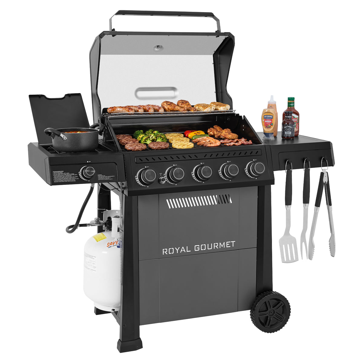 A Royal Gourmet gas grill with an open lid and grill grate, showing cooked meat, vegetables, and burgers on a white background. The grill has a side burner, a propane tank, hanging utensils, and bottles on the side table.