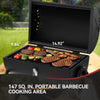 Royal Gourmet Portable barbecue grill with food on a wooden surface outdoors