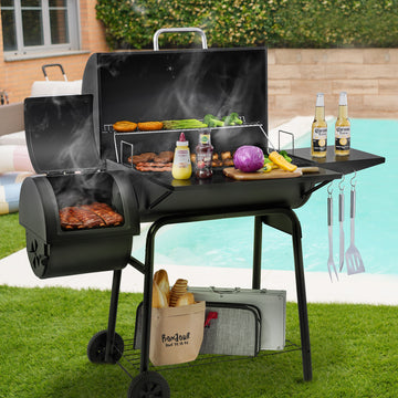 Black Royal Gourmet barbecue grill with food and beer bottles on a grassy area by a pool.