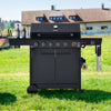 Black Royal Gourmet barbecue grill on grass with a house in the background
