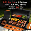 A black multi-zone Royal Gourmet outdoor grill with an open lid and extended wooden lower shelf, shown cooking ribs, steaks, burgers, corn, broccoli, tomatoes, and kebabs on a patio. Large promotional text at the top reads '824 Sq.