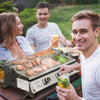 People grilling outdoors with a Royal Gourmet  portable grill and drinks.