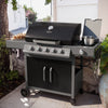 Black and silver Royal Gourmet barbecue grill on a patio with outdoor setting