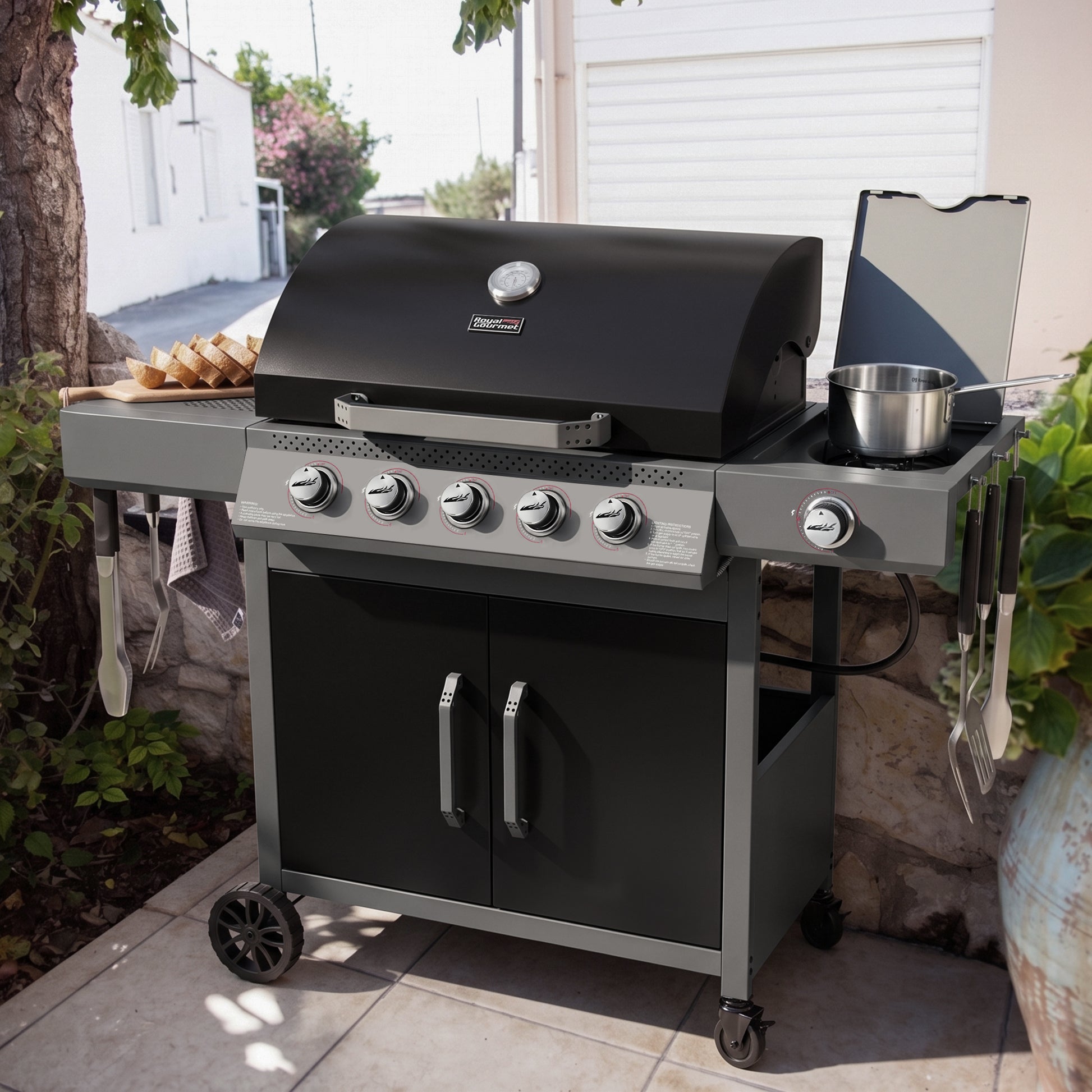 Black and silver Royal Gourmet barbecue grill on a patio with outdoor setting