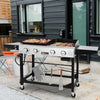 Royal Gourmet Outdoor grill with food on a patio area in front of a house.