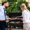 Man and woman grilling food outdoors