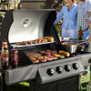 Outdoor Royal Gourmet  grill with food being cooked, people in the background