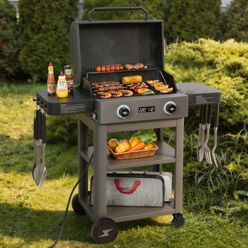 Royal Gourmet Portable grill with food and accessories on a grassy outdoor setting