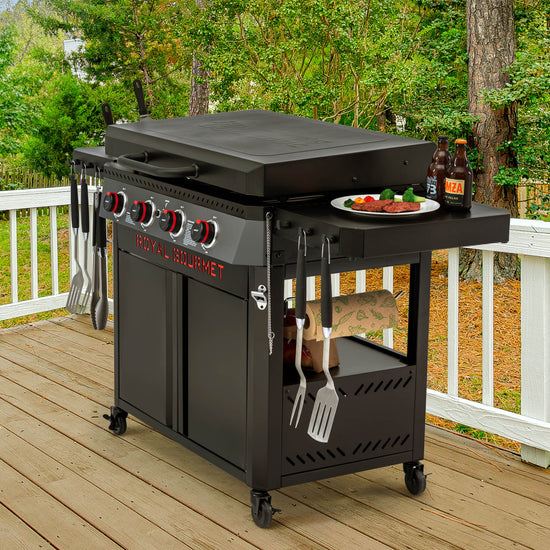 Black Royal Gourmet  barbecue grill with cooking utensils and food on a wooden deck