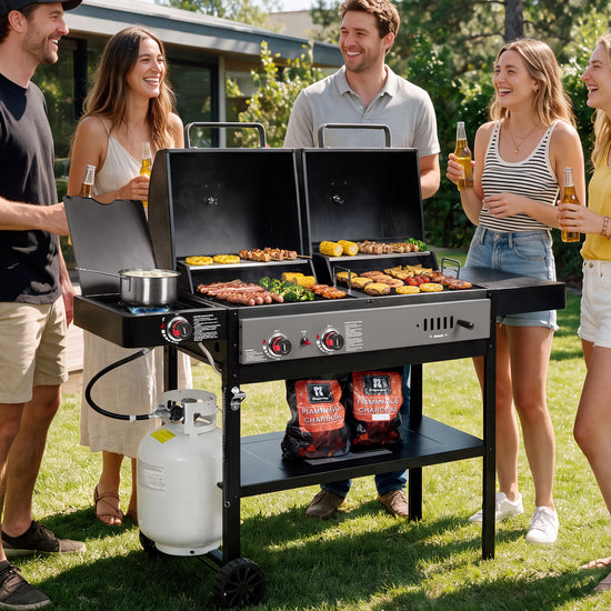 A large black Royal Gourmet dual-grill outdoor barbecue grill with multiple foods cooking on top, surrounded by four people holding beer bottles on a grassy backyard lawn. Bags of LL Coolant charcoal are visible on the lower shelf.