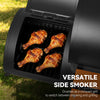 A black Royal Gourmet side smoker grill with four cooked chicken drumsticks inside, shown outdoors on grass. White text on the lower right reads 'VERSATILE SIDE SMOKER' and 'Doubles as a compact grill to switch between smoking and grilling.