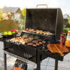 Black Royal Gourmet grill with food on a patio