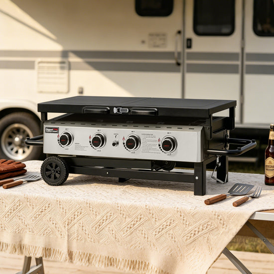 Portable outdoor Royal Gourmet grill on a table with a beer and utensils, set against an RV background.