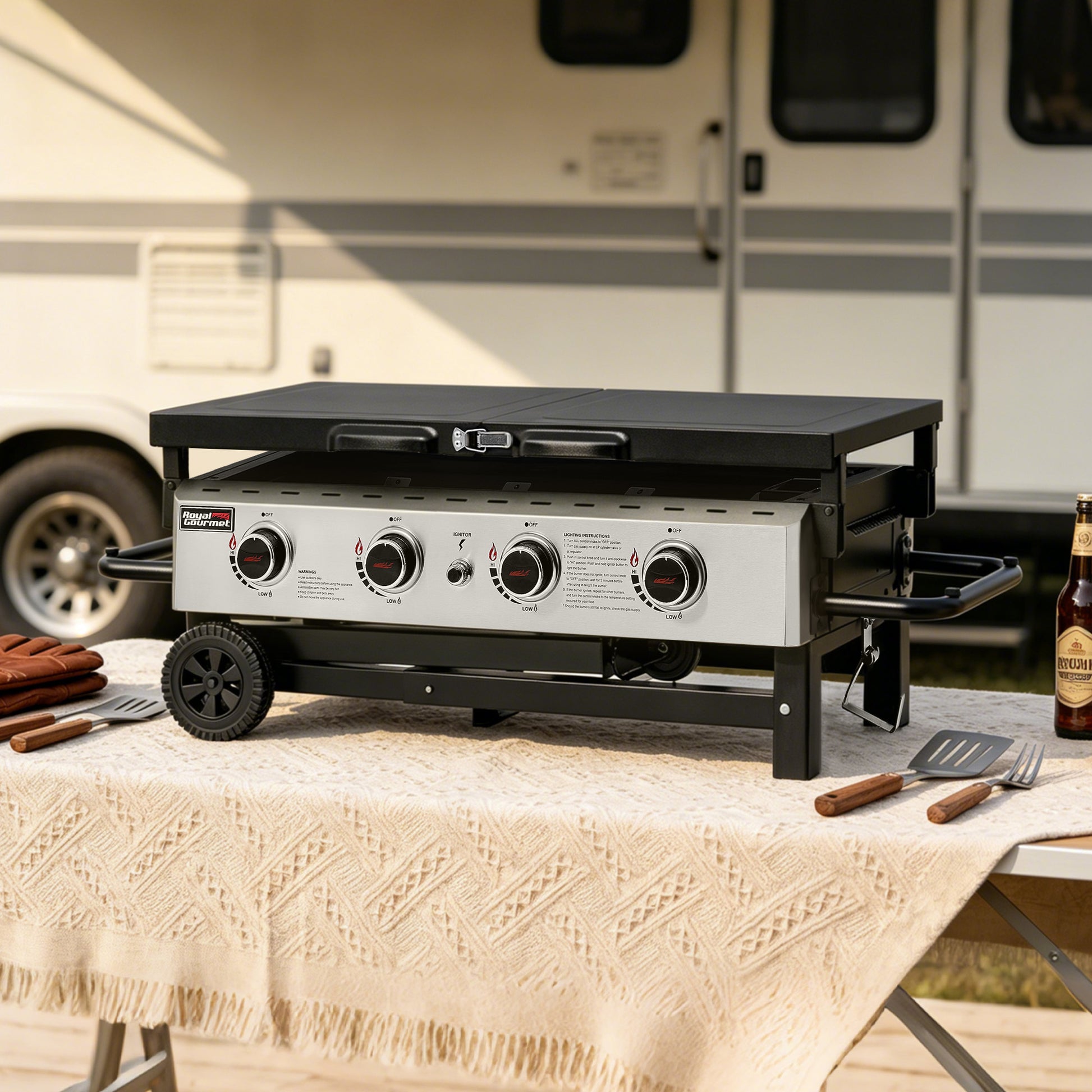 Portable outdoor Royal Gourmet grill on a table with a beer and utensils, set against an RV background.