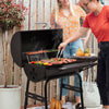 Two people grilling outdoors with a portable Royal Gourmet barbecue