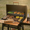Royal Gourmet Barbecue grill with various meats, vegetables, and bread on a wooden table outdoors.