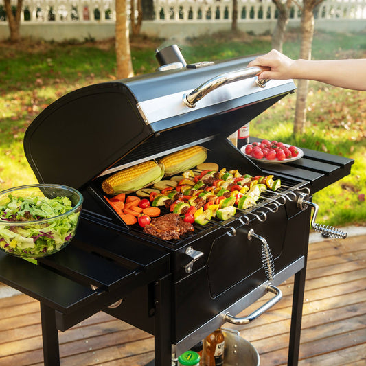 Person grilling vegetables on a Royal Gourmet portable grill outdoors