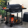 Black barbecue grill with 'Royal Gourmet' branding on a patio with potted plants and outdoor furniture.