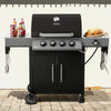 Black Royal Gourmet barbecue grill with accessories on a patio