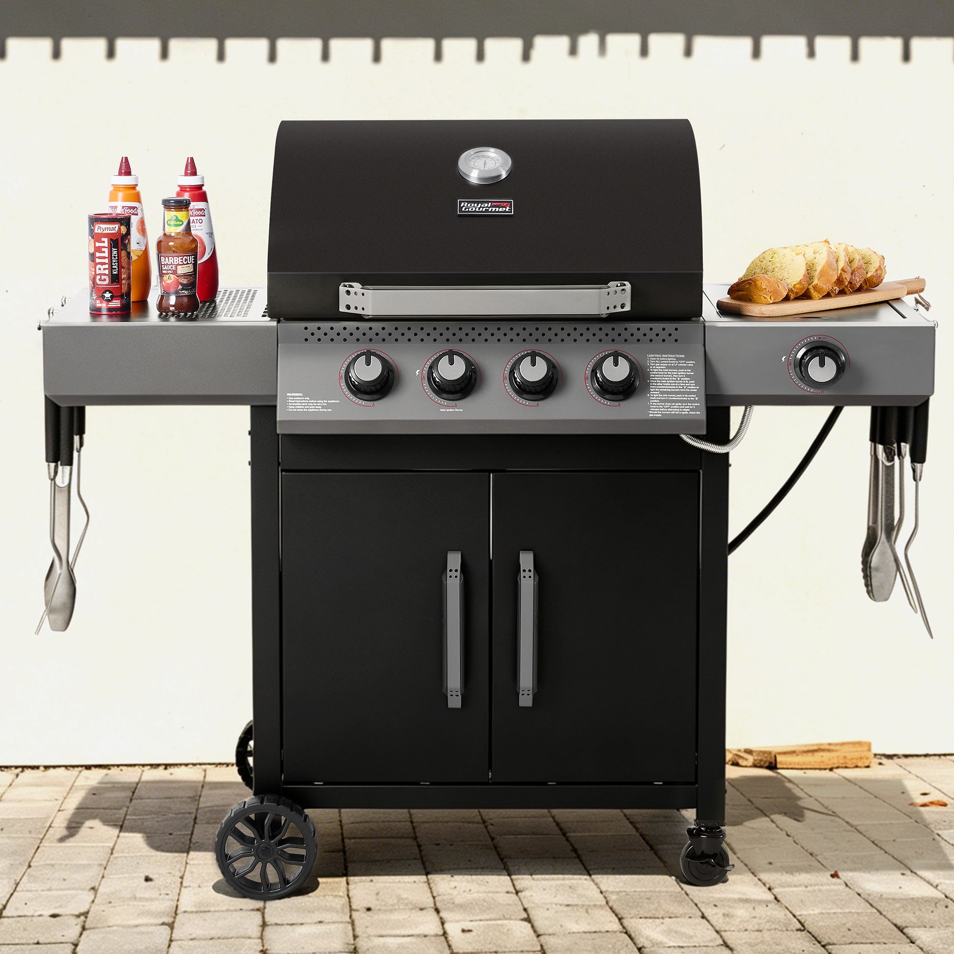 Black Royal Gourmet barbecue grill with accessories on a patio