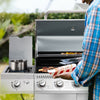 Person grilling outdoors using a portable Royal Gourmet  gas stove with a grill attachment.