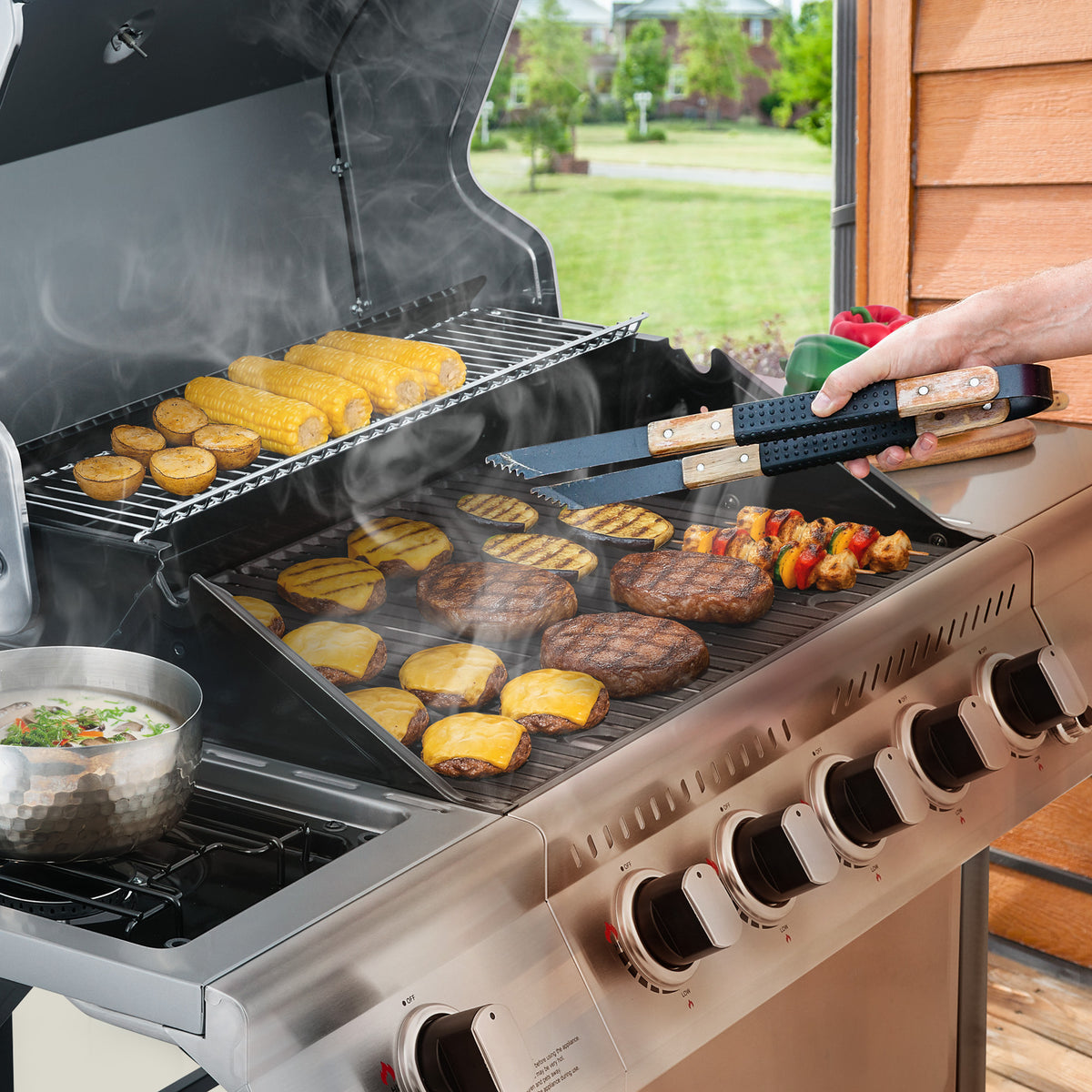 Person grilling vegetables and burgers on a Royal Gourmet gas grill outdoors.