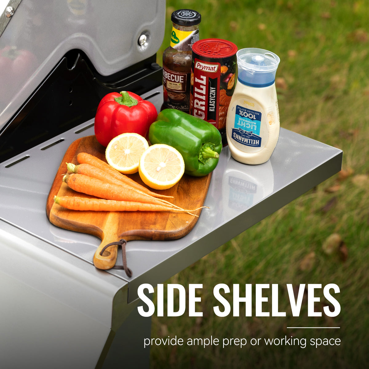 Side shelves of a Royal Gourmet  grill with vegetables and condiments on a grassy background