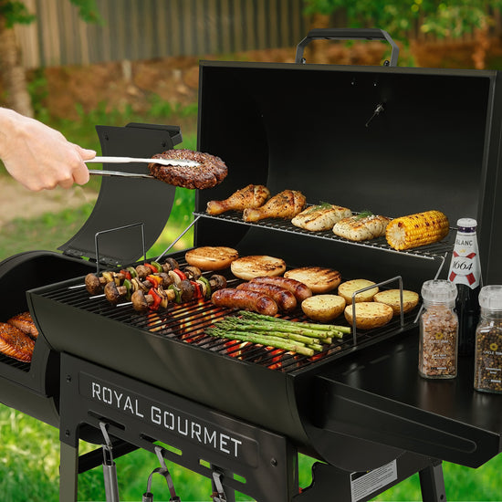 Person grilling food on a Royal Gourmet barbecue grill outdoors.