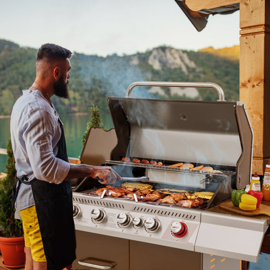 Man grilling outdoors with a scenic background