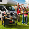 Family with children near a camper van and outdoorRoyal Gourmet  kitchen setup on grass