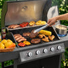 Person grilling various food items on a Royal Gourmet barbecue grill with a bottle of beer nearby.
