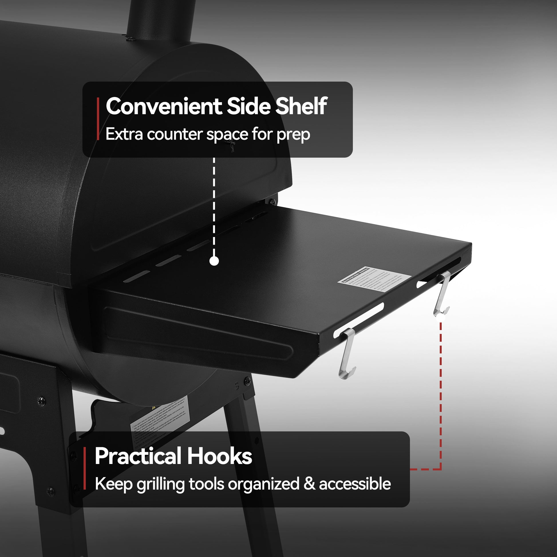 Black barbecue grill with a side shelf and hooks on a gray background