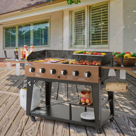 Royal Gourmet Outdoor grill with food on a wooden deck