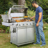 Man grilling outdoors using a large Royal Gourmet stainless steel barbecue grill.