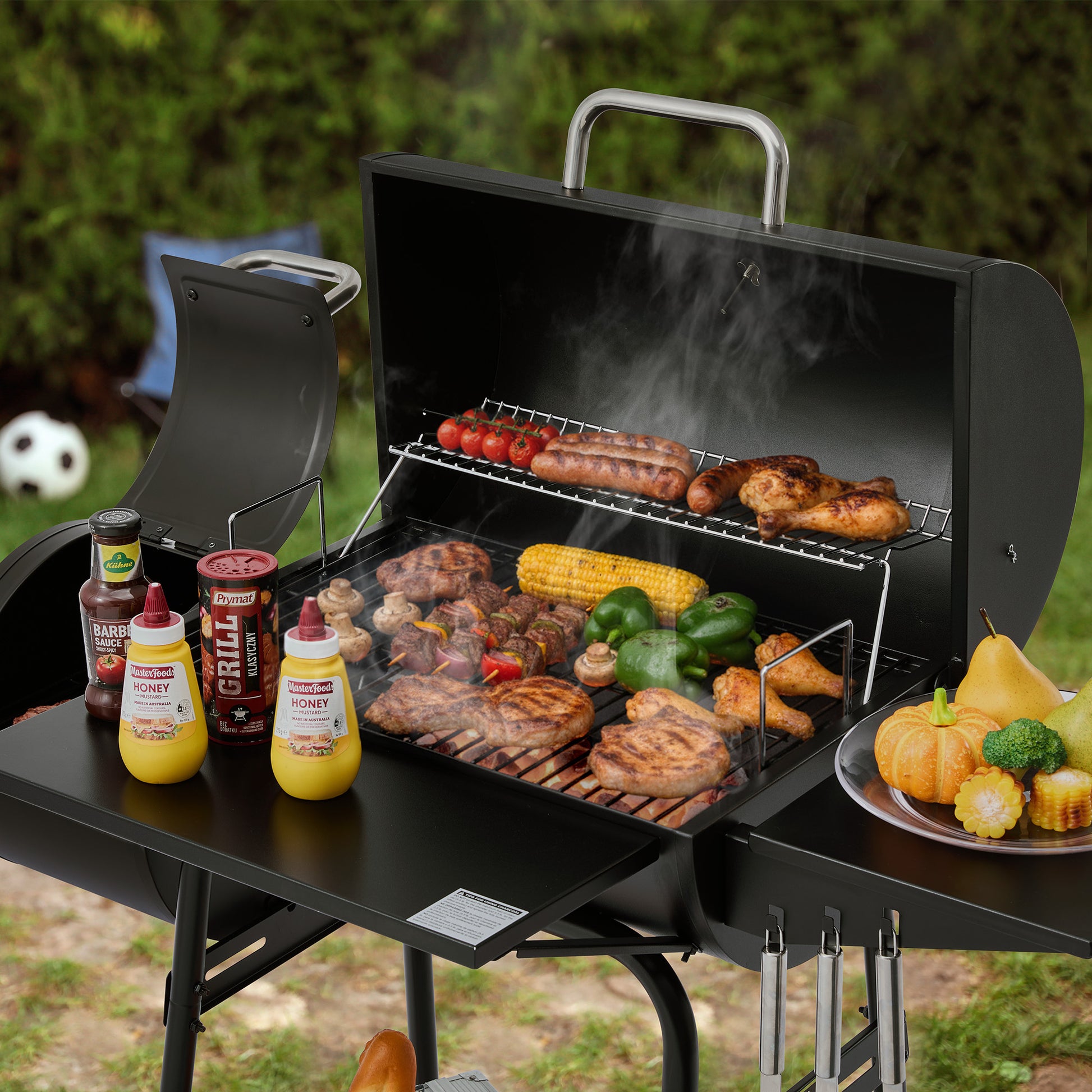 Royal Gourmet Portable grill with food and condiments on a table outdoors