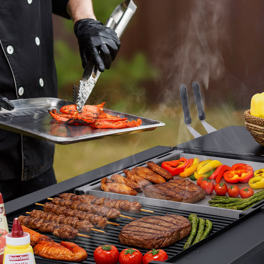 Person grilling various meats and vegetables on a barbecue with smoke rising.