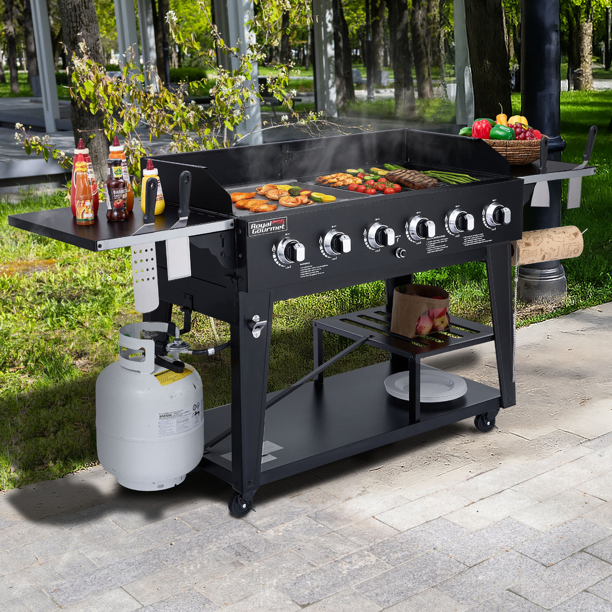 Black Royal Gourmet  barbecue grill with food and accessories on a patio