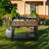 Royal Gourmet Outdoor grill with food and condiments on a grassy lawn in front of a house.
