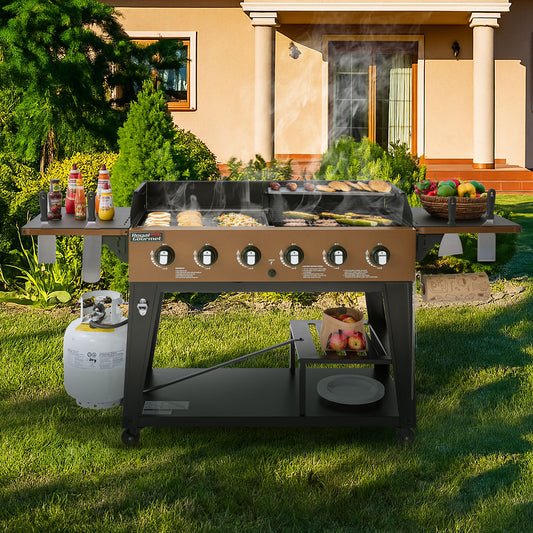 Royal Gourmet Outdoor grill with food and condiments on a grassy lawn in front of a house.