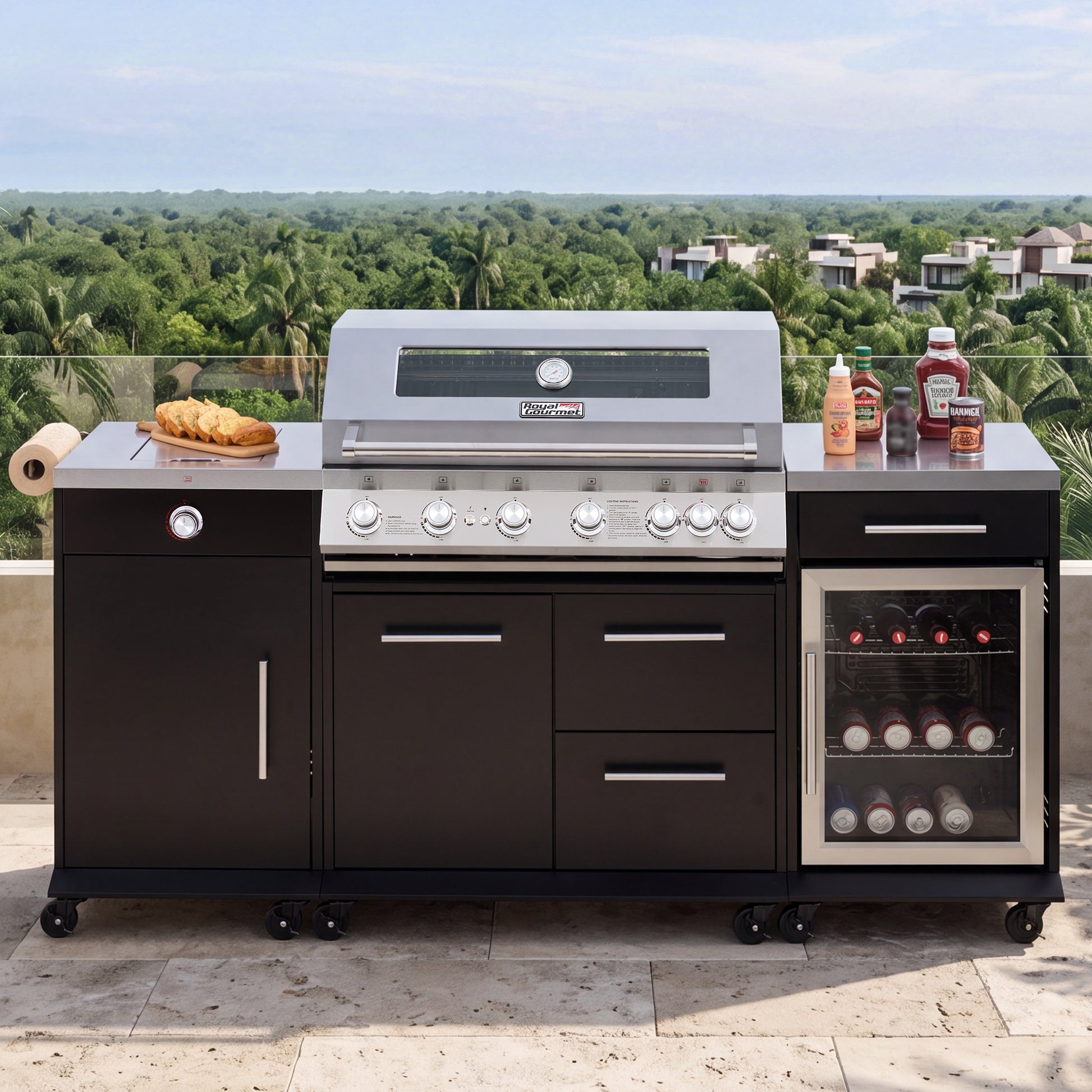 A large Royal Gourmet  outdoor kitchen island set with a stainless steel gas grill, dark charcoal cabinets, a wine cooler, and countertop accessories, photographed on a patio with a tropical landscape background.