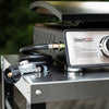 Royal Gourmet Portable gas stove with hose and connectors on a reflective surface, brand 'Royal Gourmet' visible.