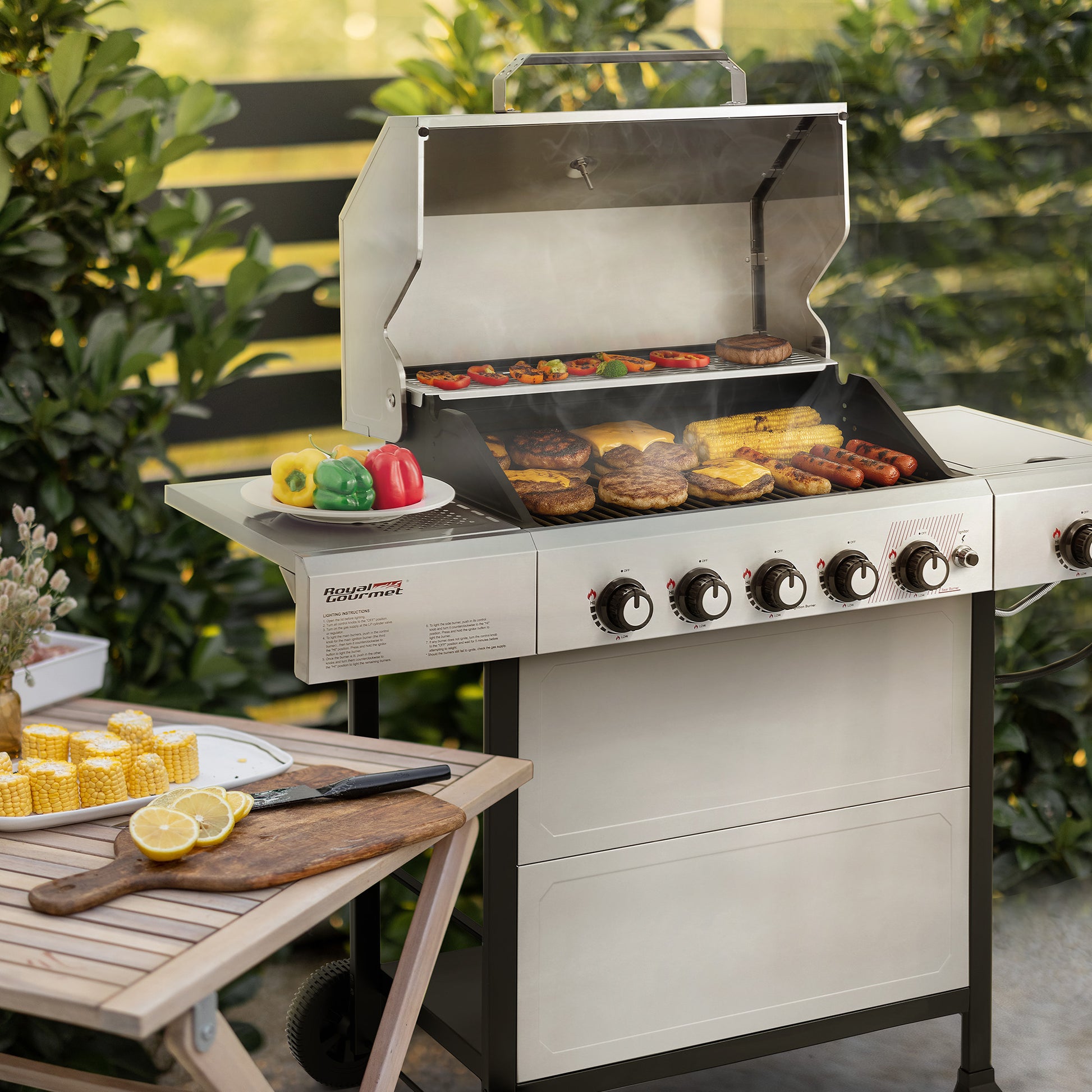 Outdoor Royal Gourmet grill with food being cooked, surrounded by greenery