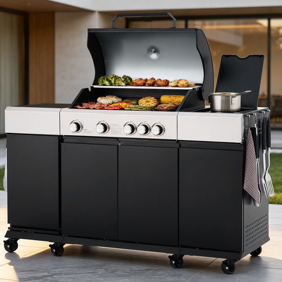 A large black and white Royal Gourmet outdoor  gas grill with the lid open, showing cooked food on multiple grates, set on a patio in front of a modern house. A small metal pot sits on the side table, and utensils hang from a side rack.