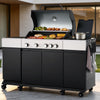 A large black and white Royal Gourmet outdoor  gas grill with the lid open, showing cooked food on multiple grates, set on a patio in front of a modern house. A small metal pot sits on the side table, and utensils hang from a side rack.