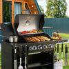 Royal Gourmet Black barbecue grill with food and utensils in an outdoor setting