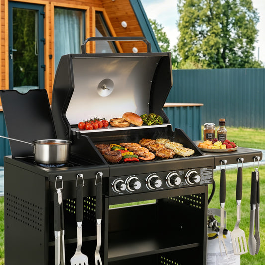 Royal Gourmet Black barbecue grill with food and utensils in an outdoor setting